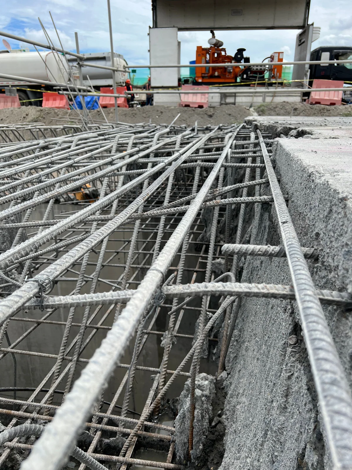 Exposed reinforcement and the remaining concrete edge in Dezu's railway concrete-removal work area