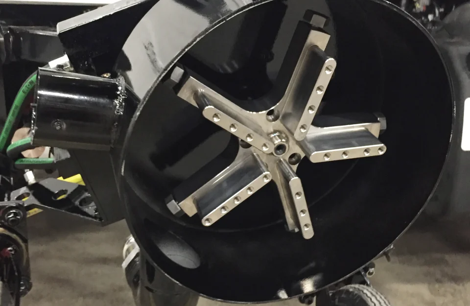 Underside of the stationary NLB SpinJet rotary head showing its star-shaped nozzle arrangement